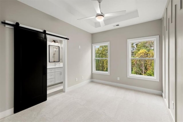 2329 Mason Dr Unit D24, Atlanta, GA 30316 - unfurnished bedroom with light colored carpet, a barn door, baseboards, a sink, and ensuite bath