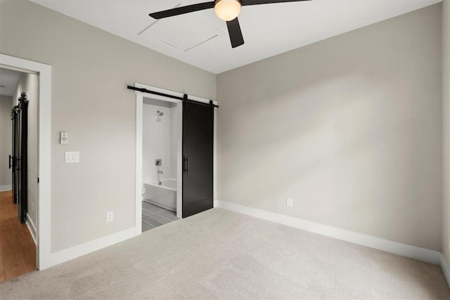 2329 Mason Dr Unit D24, Atlanta, GA 30316 - unfurnished bedroom featuring carpet, a barn door, and baseboards