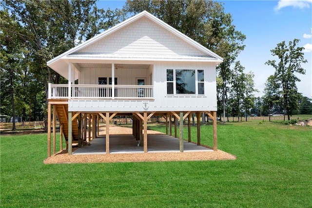 rear view of house with a carport and a lawn