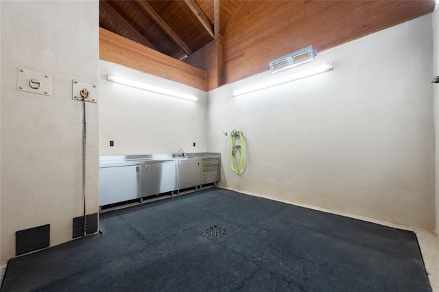 interior space with concrete floors, high vaulted ceiling, and wood ceiling