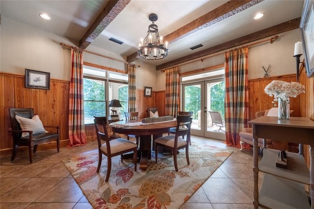 dining room featuring beam ceiling, a chandelier, a wealth of natural light, and french doors