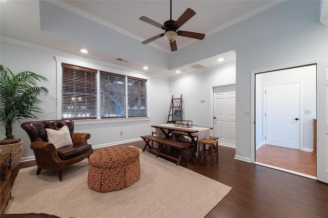 living area featuring ceiling fan, ornamental molding, and hardwood / wood-style floors