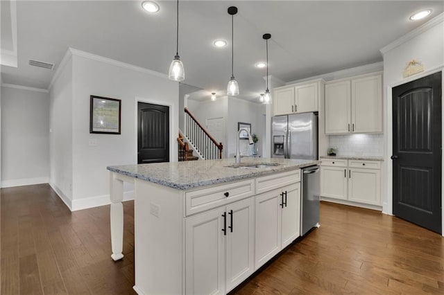 3940 Frasier Dr, Cumming, GA 30028 - kitchen with stainless steel appliances, dark wood-style flooring, decorative backsplash, hanging light fixtures, and crown molding