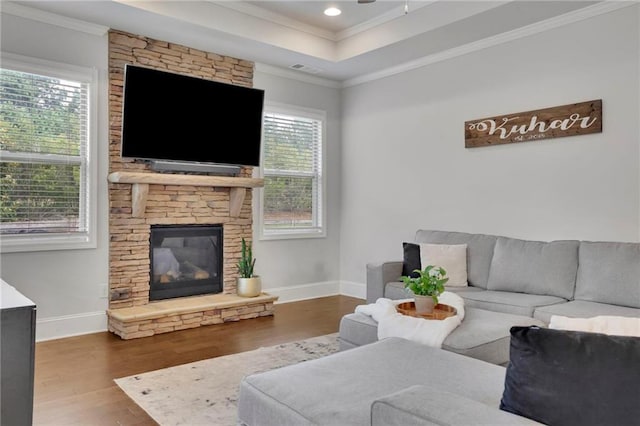 3940 Frasier Dr, Cumming, GA 30028 - living area with wood finished floors, ornamental molding, a fireplace, recessed lighting, and a tray ceiling