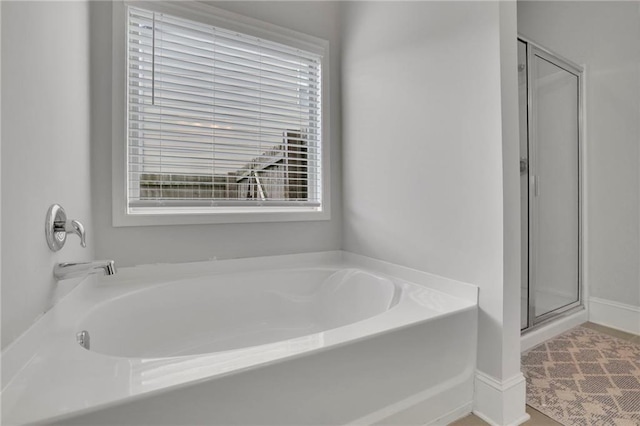 3940 Frasier Dr, Cumming, GA 30028 - bathroom with plenty of natural light, a bath, and a stall shower