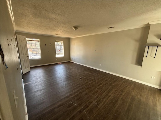 spare room with dark hardwood / wood-style flooring, ornamental molding, and a textured ceiling