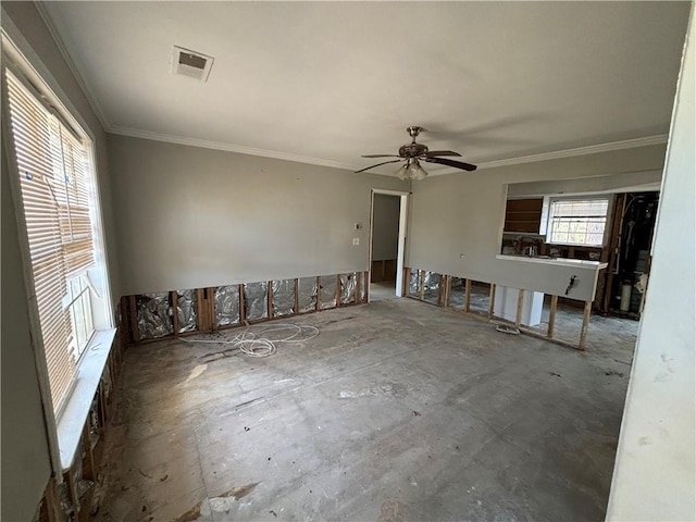 unfurnished room with ceiling fan and ornamental molding