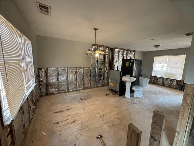 interior space with pendant lighting and sink