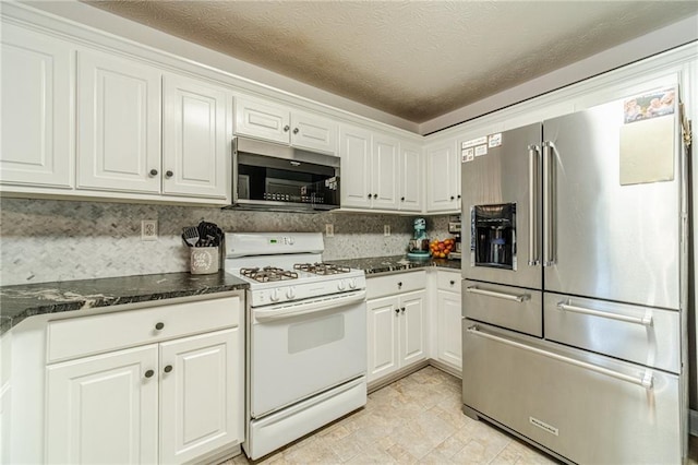 1623 Pratt Rd, Covington, GA 30014 - kitchen featuring appliances with stainless steel finishes, white cabinetry, and dark stone countertops