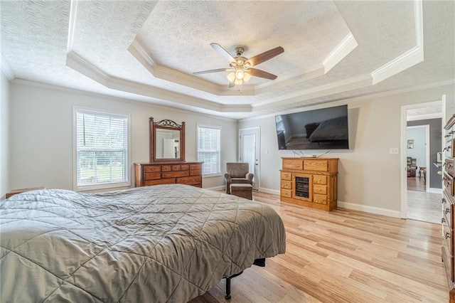1623 Pratt Rd, Covington, GA 30014 - bedroom featuring a textured ceiling, a raised ceiling, ornamental molding, light wood-type flooring, and ceiling fan