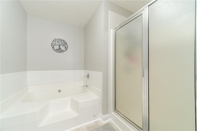 1623 Pratt Rd, Covington, GA 30014 - full bathroom featuring a bath, a shower stall, and a textured ceiling