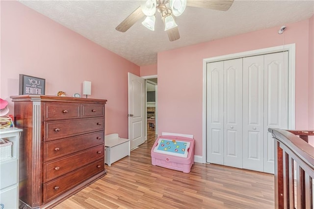 1623 Pratt Rd, Covington, GA 30014 - bedroom featuring light wood-type flooring, a textured ceiling, a closet, and a ceiling fan