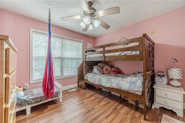 1623 Pratt Rd, Covington, GA 30014 - bedroom featuring wood finished floors, a textured ceiling, and ceiling fan