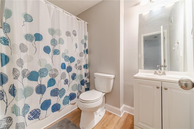 1623 Pratt Rd, Covington, GA 30014 - full bathroom with wood finished floors, vanity, and curtained shower