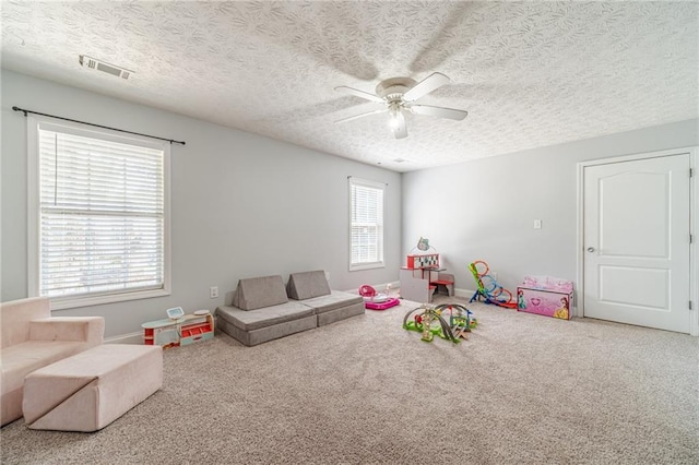 1623 Pratt Rd, Covington, GA 30014 - playroom featuring a ceiling fan, carpet, and a textured ceiling