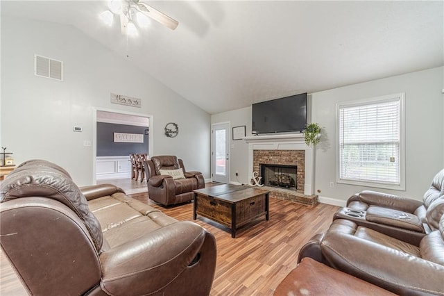 1623 Pratt Rd, Covington, GA 30014 - living room with ceiling fan, light wood finished floors, a brick fireplace, and high vaulted ceiling