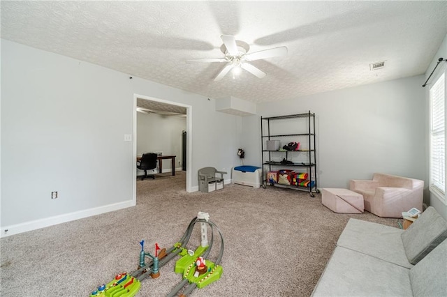 1623 Pratt Rd, Covington, GA 30014 - carpeted living room with ceiling fan and a textured ceiling