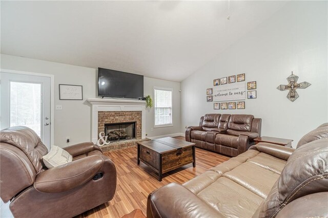 1623 Pratt Rd, Covington, GA 30014 - living room featuring light wood finished floors, lofted ceiling, and a fireplace
