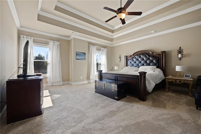 bedroom with light colored carpet, ornamental molding, a tray ceiling, and multiple windows