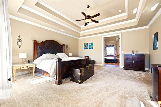 bedroom with crown molding, light carpet, ceiling fan, and a tray ceiling