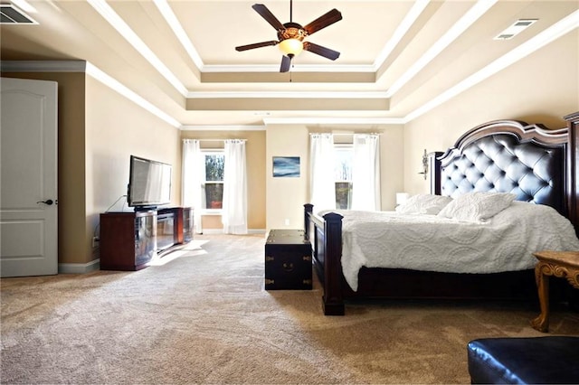 bedroom featuring crown molding, ceiling fan, a tray ceiling, and carpet