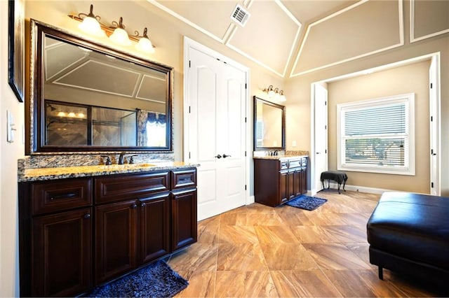 bathroom featuring vanity and vaulted ceiling