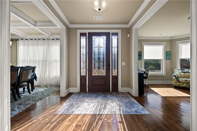 foyer entrance with crown molding and dark hardwood / wood-style floors