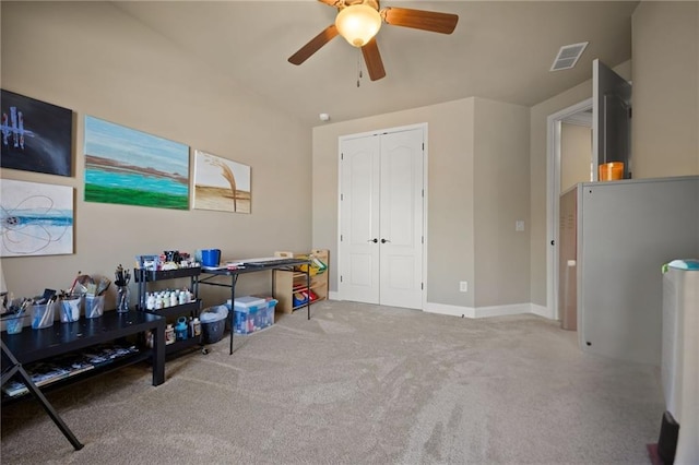 interior space featuring ceiling fan and carpet flooring