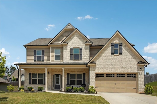 craftsman inspired home with a garage, brick siding, fence, concrete driveway, and a front lawn