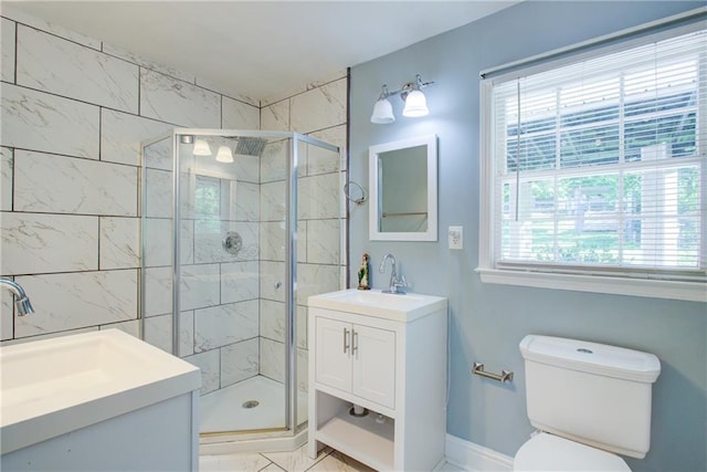 full bath with a stall shower, baseboards, vanity, and toilet