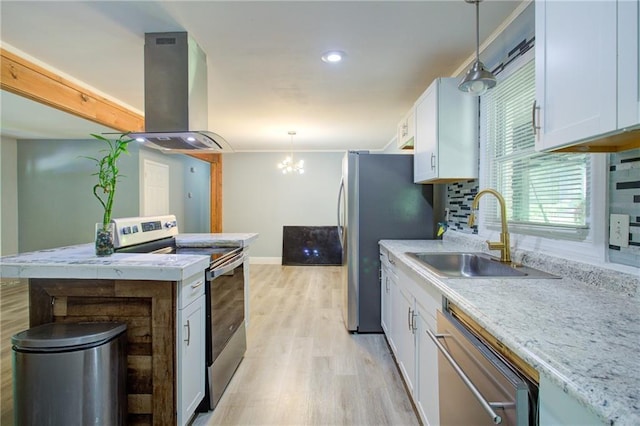 kitchen with light wood finished floors, a sink, island range hood, stainless steel appliances, and white cabinets