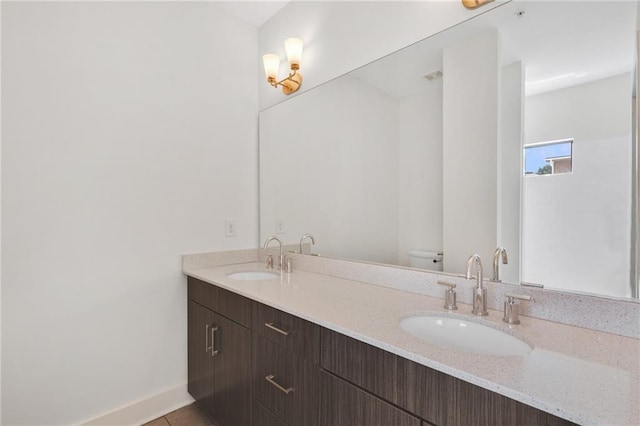 bathroom featuring tile patterned flooring, vanity, and toilet