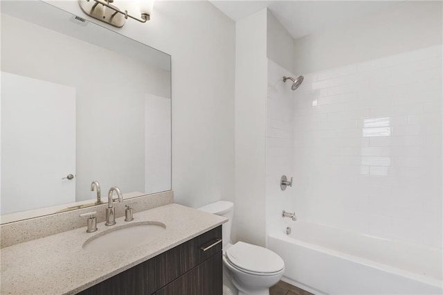 full bathroom with vanity, toilet, and tiled shower / bath