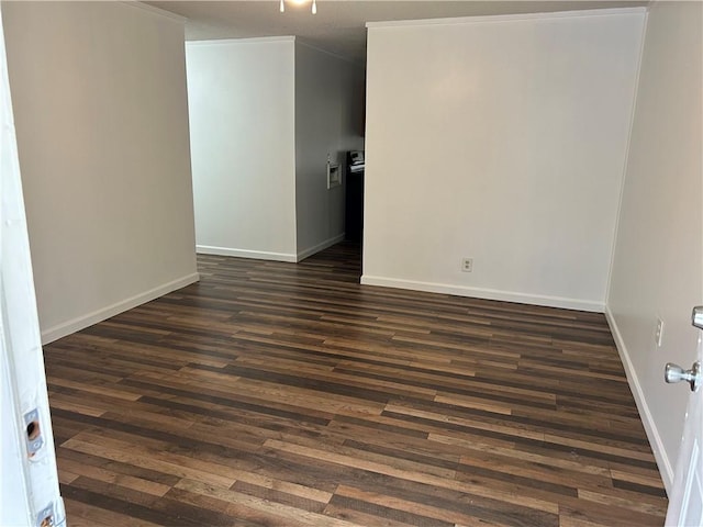 unfurnished room featuring dark hardwood / wood-style flooring and ornamental molding