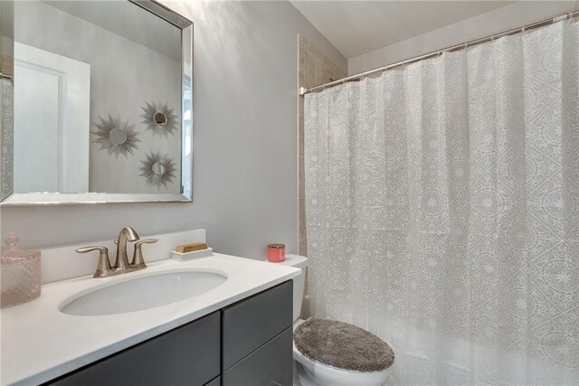 bathroom featuring vanity and toilet