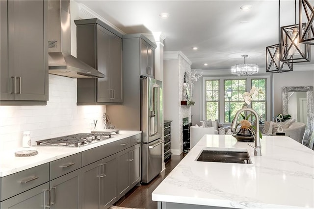 kitchen featuring sink, gray cabinets, stainless steel appliances, and wall chimney exhaust hood