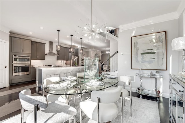 dining area featuring crown molding, dark wood-type flooring, sink, and an inviting chandelier