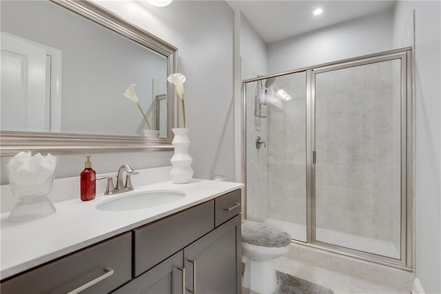 bathroom with an enclosed shower, vanity, and toilet