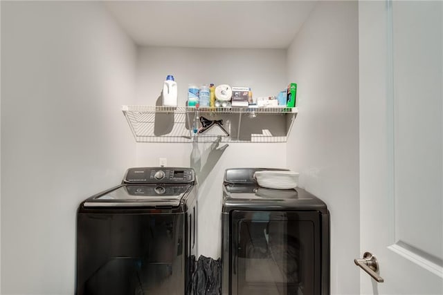 clothes washing area featuring independent washer and dryer