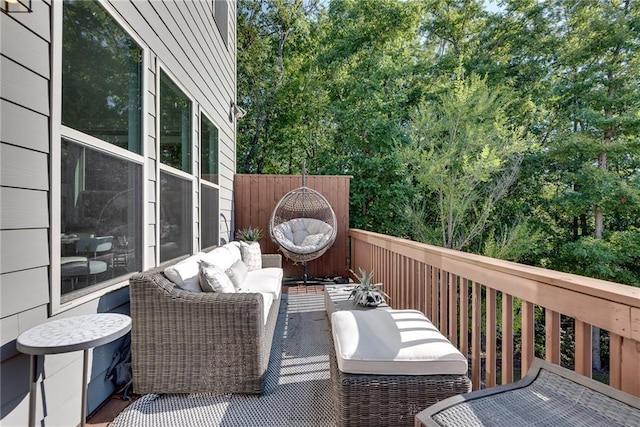 wooden balcony featuring a wooden deck and an outdoor living space