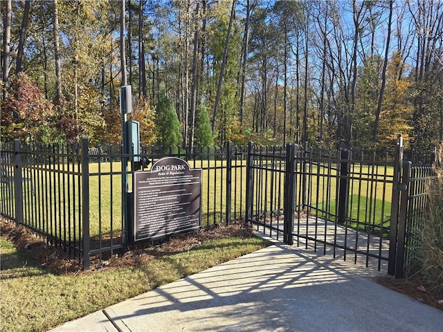 view of gate featuring a yard