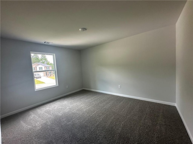 15 Fontana Ct, Covington, GA 30016 - spare room featuring dark colored carpet and baseboards