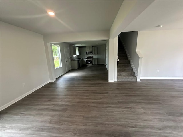 15 Fontana Ct, Covington, GA 30016 - unfurnished living room featuring stairway, dark wood finished floors, and recessed lighting