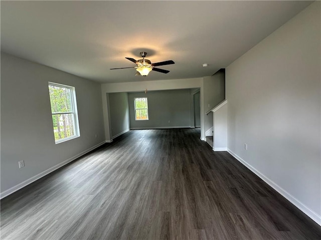 15 Fontana Ct, Covington, GA 30016 - unfurnished living room with dark wood-style floors, a ceiling fan, and stairs