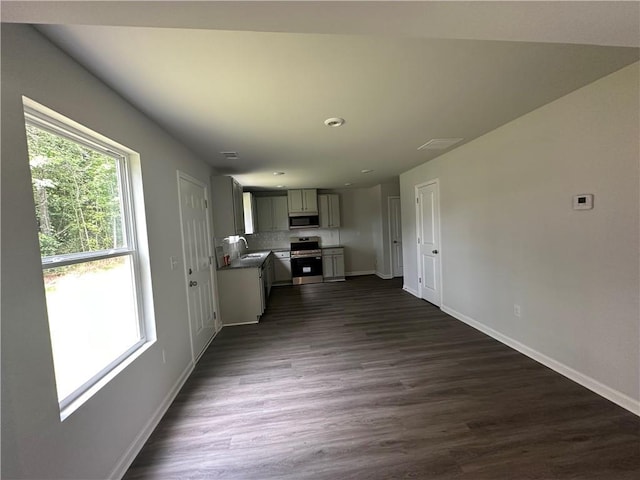 15 Fontana Ct, Covington, GA 30016 - kitchen with appliances with stainless steel finishes, dark wood-style floors, gray cabinets, and tasteful backsplash