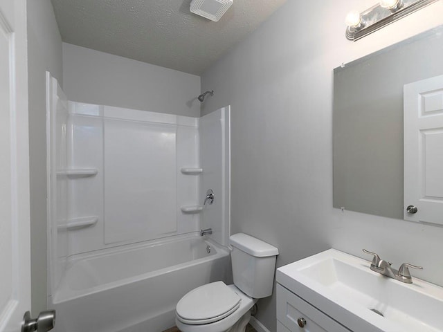 full bathroom featuring vanity, toilet, shower / bathing tub combination, and a textured ceiling