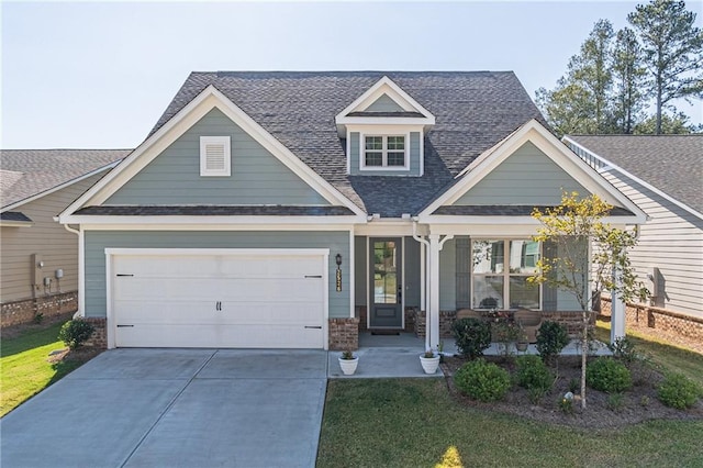 craftsman-style house with a porch, a front yard, and a garage