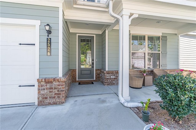 entrance to property with a garage and a porch