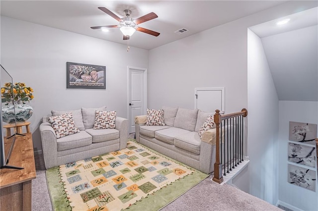 carpeted living room featuring ceiling fan and vaulted ceiling