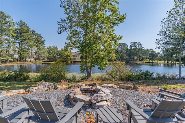 view of patio featuring an outdoor fire pit and a water view